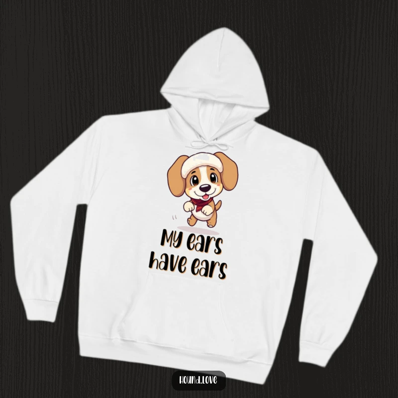 Funny hoodie depicting a playful hound character taking a tumble while sporting oversized, floppy ear muffs, ideal for winter laughs.