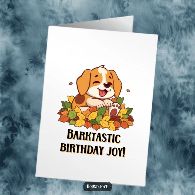 Funny Free Printable Birthday Card: A giggling hound dog with a wide smile rolling around gleefully in a huge pile of autumn leaves.