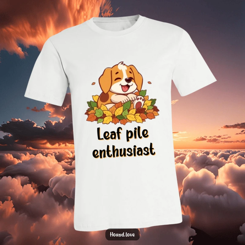 Funny t-shirt featuring a gleeful hound character with an open mouth mid-bark, blissfully rolling around in a huge mound of fallen autumn leaves.
